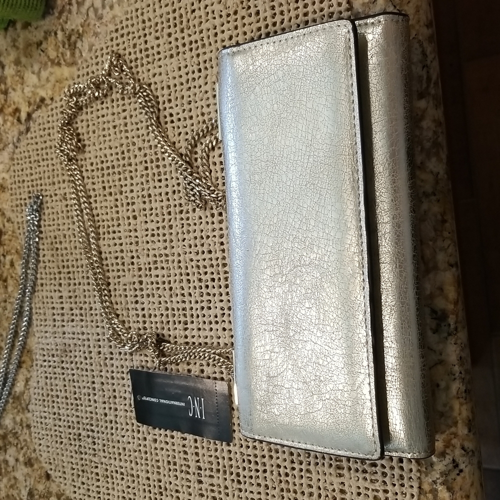 INC Womens metallic gold crossbody clutch with gold shoulder length chain.